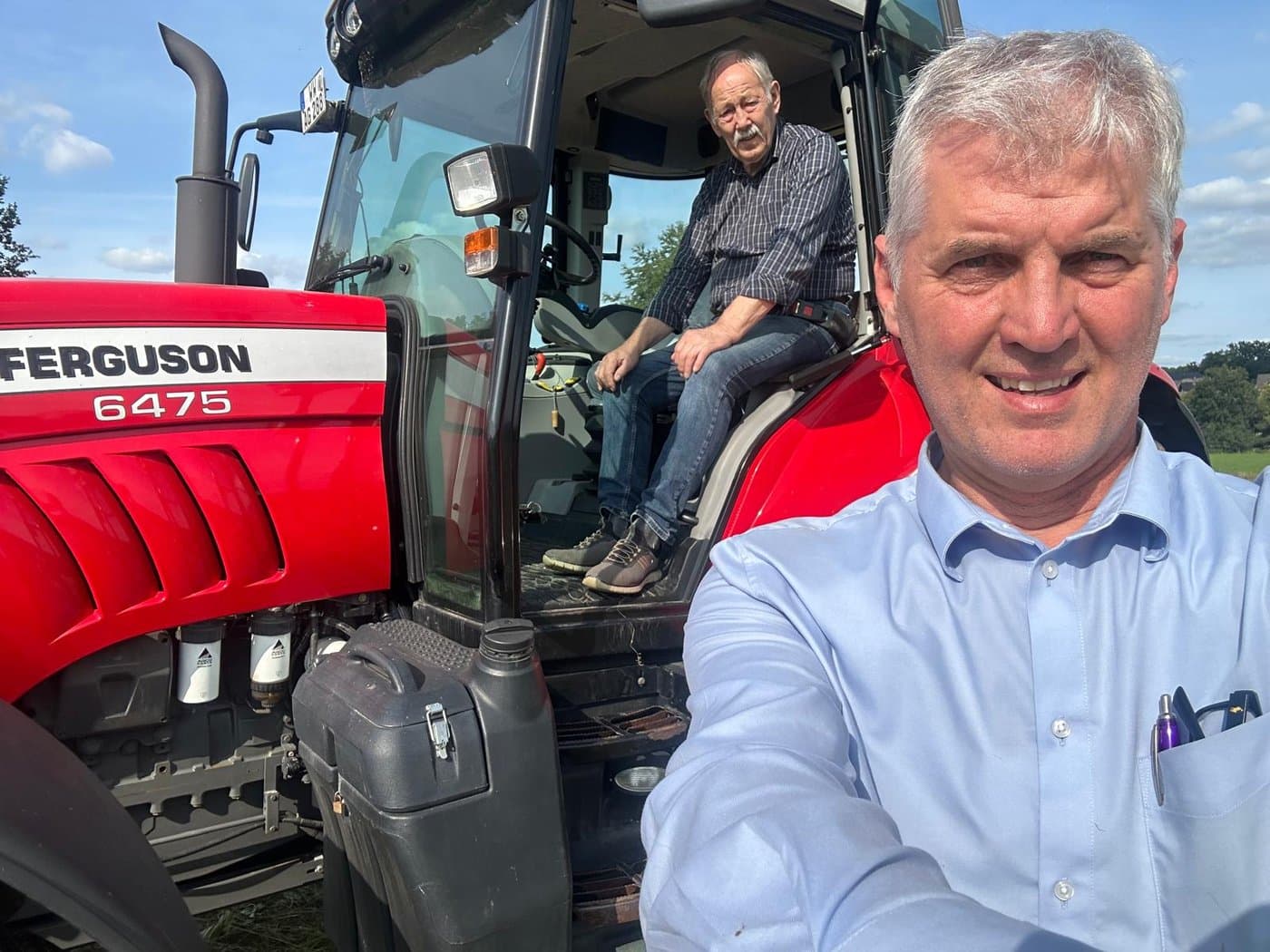 Guido Pusch with farm resident on tractor