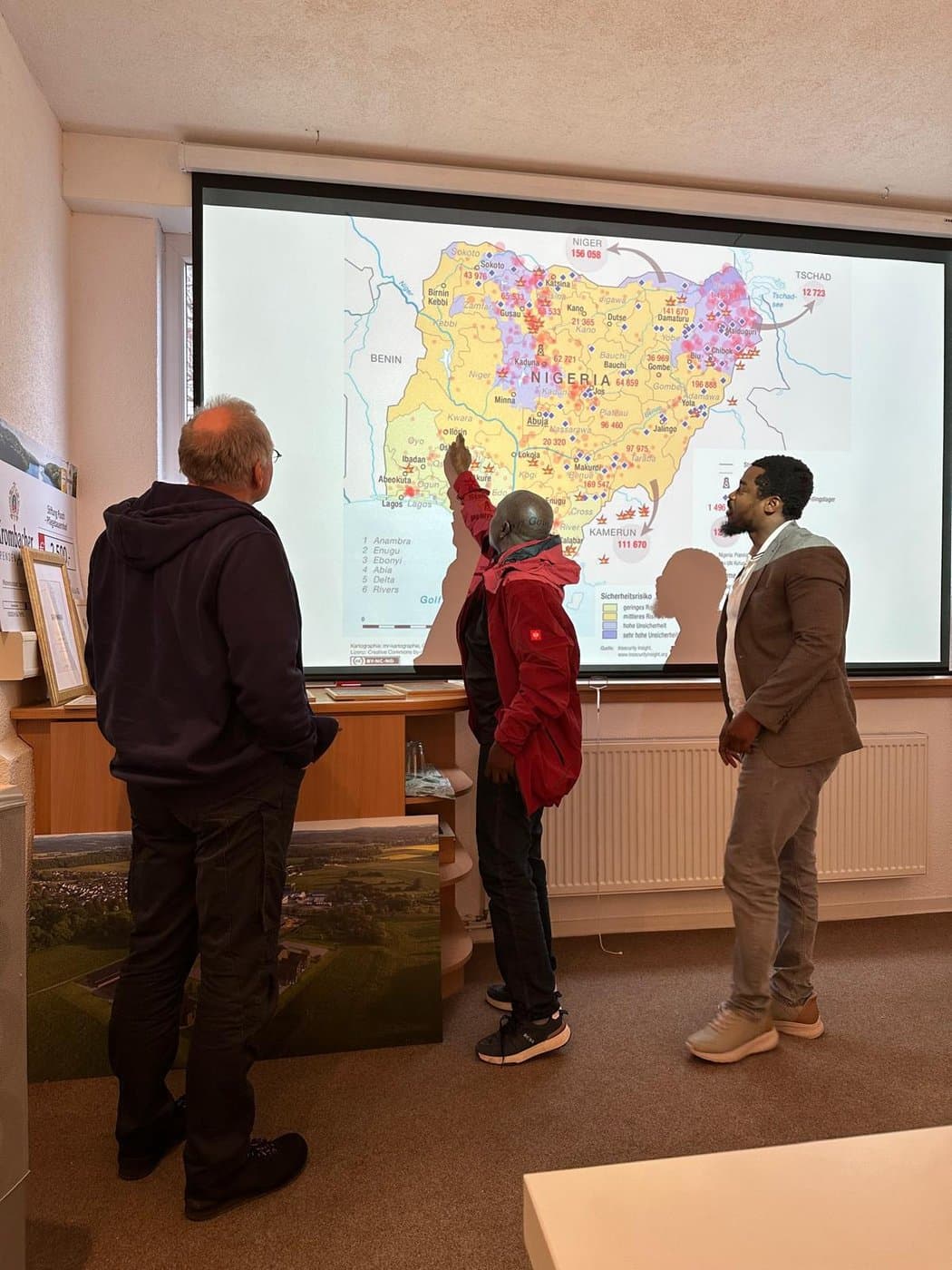 Nigerian delegation studying Nigeria map in Germany